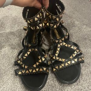BCBGMaxAzria black and gold gladiator sandals
